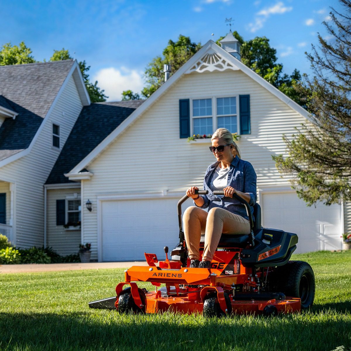 A woman riding a lawn mower in a yard Game Arcade